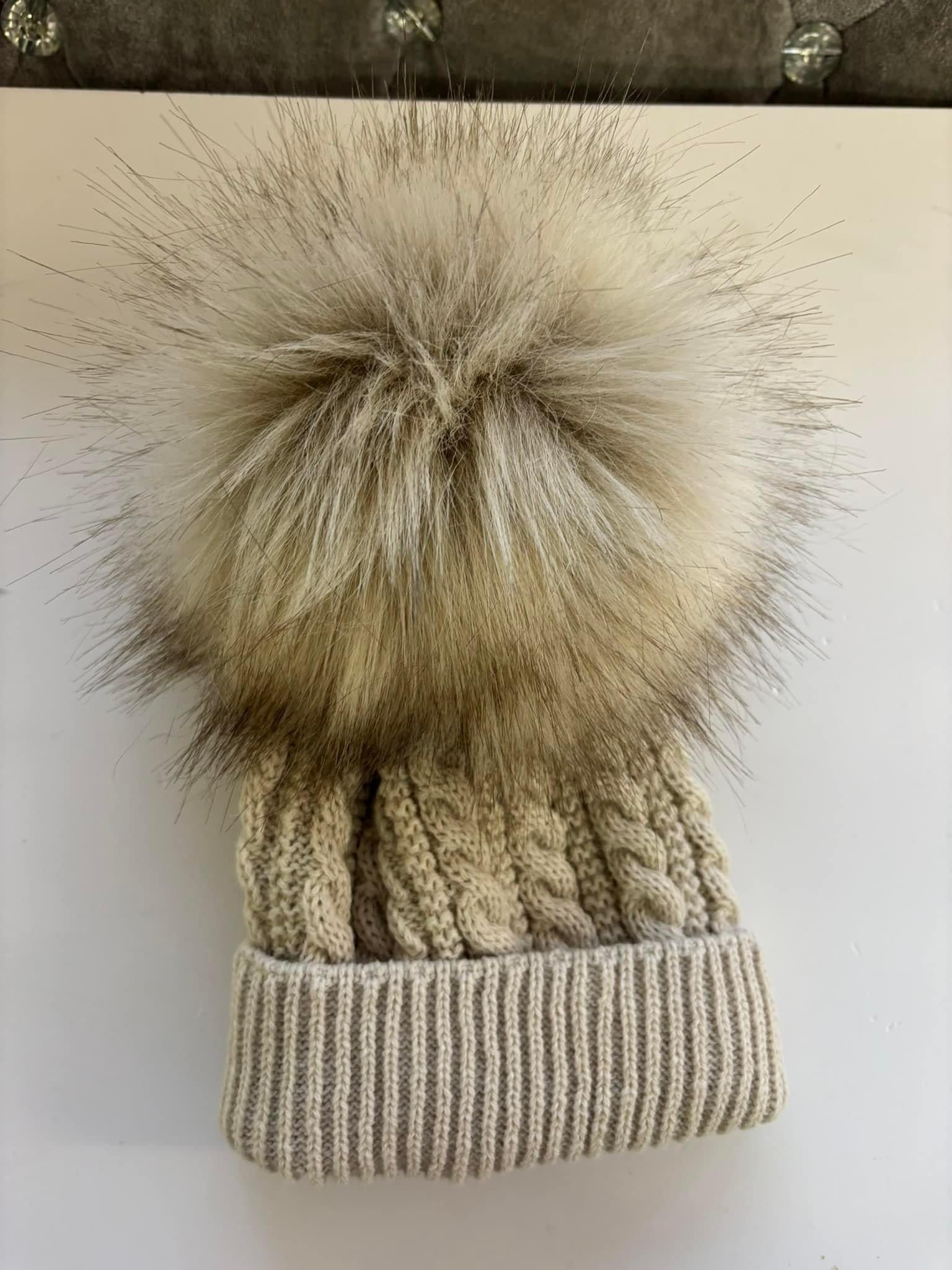 Beige knitted extra large pom pom hat