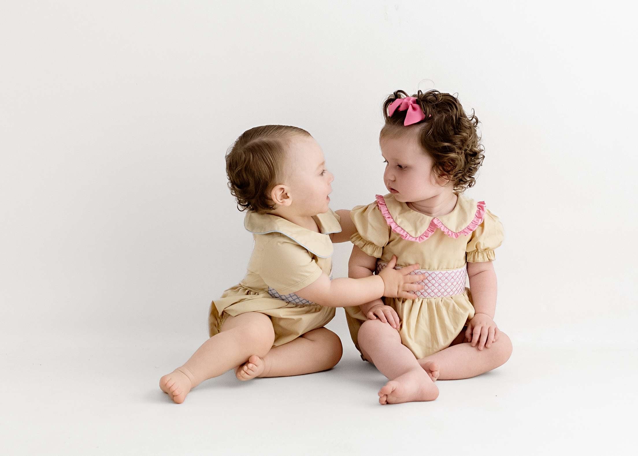 Cream & pink smocked baby girls rompers